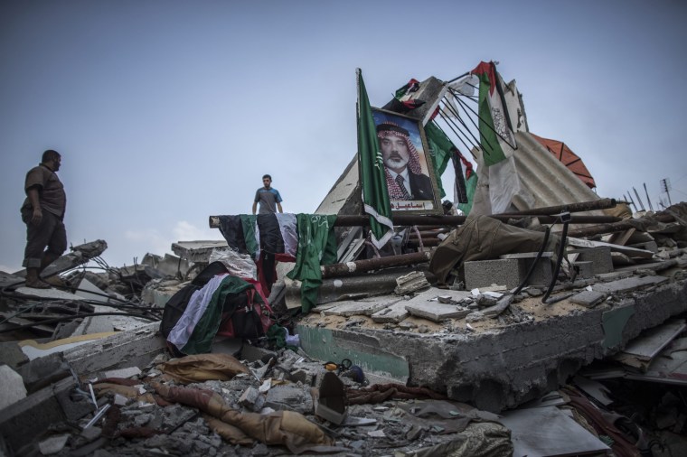 A picture of deputy chief of the Hamas movement, Ismail Haniya, is displayed amidst the rubble of his house, which was destroyed in an overnight Israeli airstrike in Gaza City, July 29, 2014.