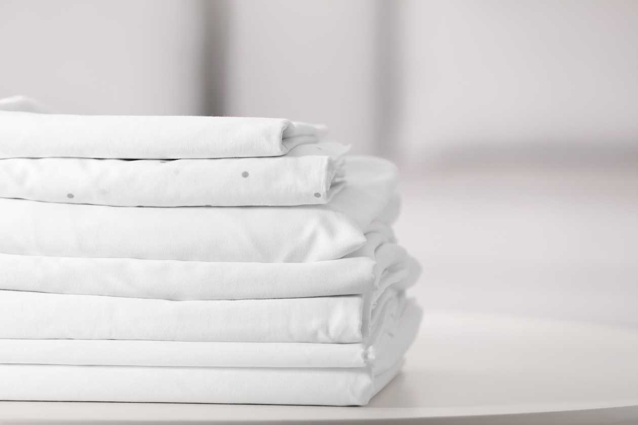 clean folded bed linen sheets
