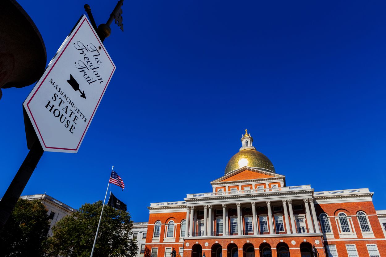 Freedom Trail sign and the Massachusetts State House