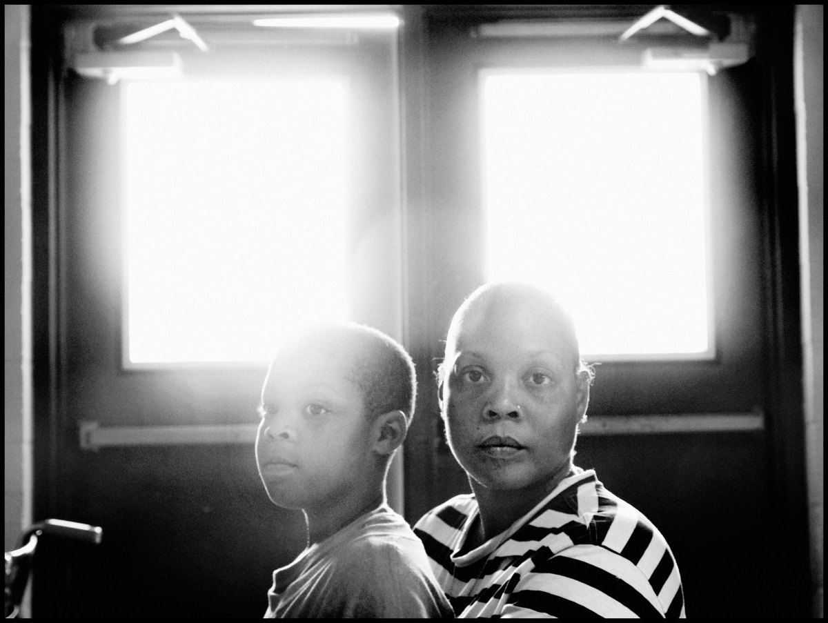 USA. Louisiana. 2005. Bayou Black Recreation Center. Ochame RILEY and her son Damone DAVIS at a shelter set up for flood refugees.