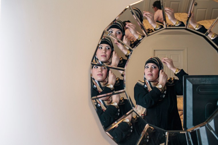 Yazmin Ali adjusts her hijab at her home in Fredericksburg, Va. on Dec. 19, 2015.