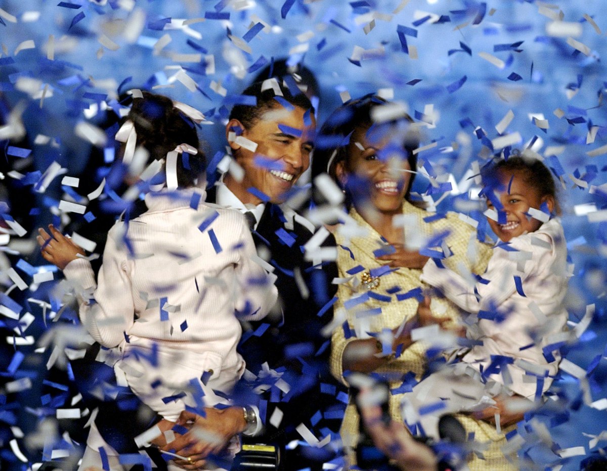 Barack Obama, holding his daughter Malia, 6, and his wife Michelle, holding their daughter Sasha, 3, are covered in confetti after Obama delivered his acceptance speech in Chicago, Nov. 2, 2004.