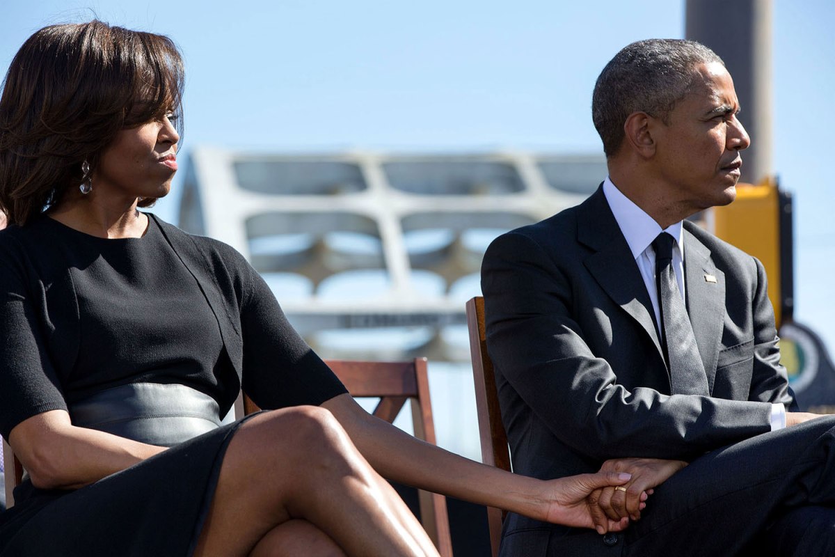 The President and First Lady hold hands as they listen to the remarks of Rep. John Lewis at an event to commemorate the 50th Anniversary of Bloody Sunday and the Selma to Montgomery civil rights marches on March 7, 2015.