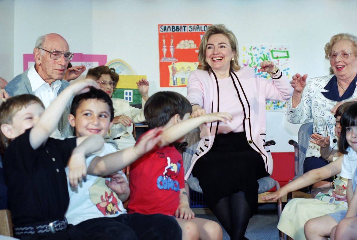 First Lady Hillary Rodham Clinton does stretching exercises with a group of youngsters and senior citizens at the Heritage Cleveland Circle Assisted Living Facility in Brookline, Mass. on May 23, 1995 during a visit to the Boston area focused on health care.