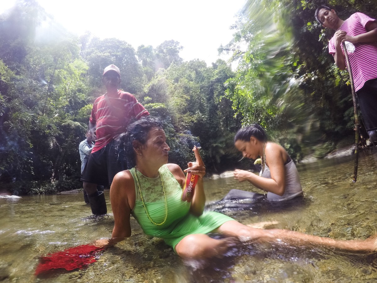 Marta and Liset rest in the river after a treacherous crossing in the DariÃ©n Gap on June 12.