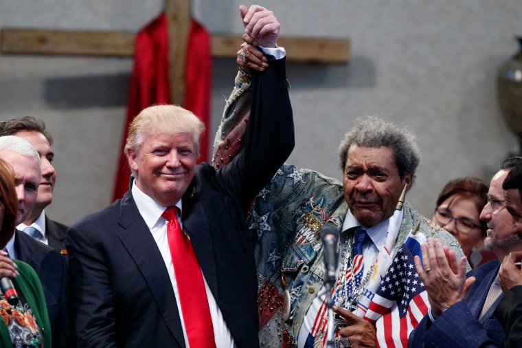 Boxing promoter Don King holds up the hand of Donald Trump during a visit to the Pastors Leadership Conference at New Spirit Revival Center, on Sept. 21, 2016, in Cleveland, Ohio.