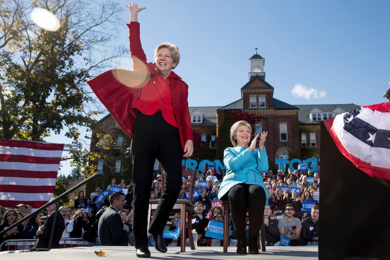 Sen. Elizabeth Warren, accompanied by Hillary Clinton, waves as she takes the stage at a rally, on Oct. 24, 2016, in Manchester, N.H.