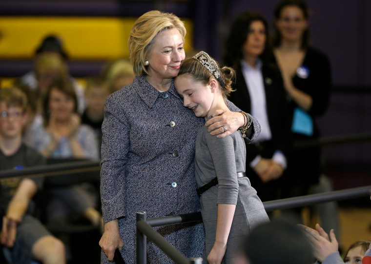 Hillary Clinton gets a hug from fifth-grader Hannah Tandy during a town hall meeting at Keota High School, on Dec. 22, 2015, in Keota, Iowa.
