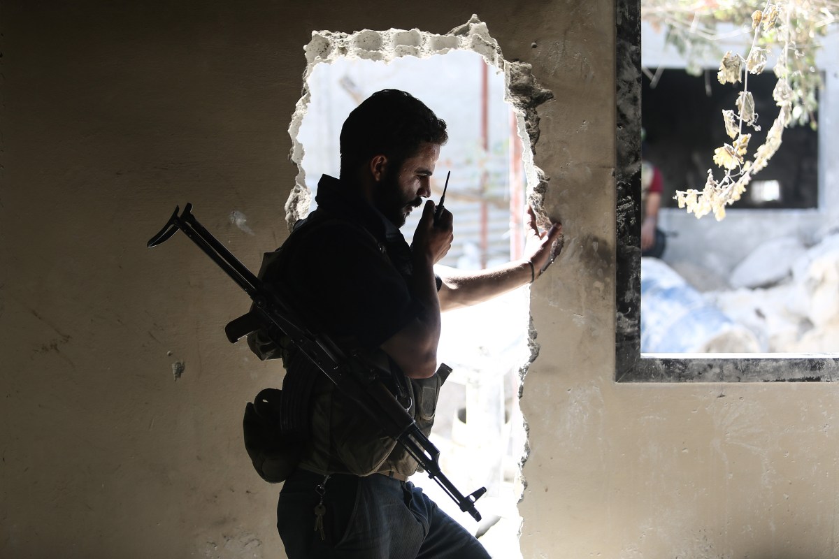 An opposition fighter communicates via radio in Douma on Sept. 5. Mohammed Badraâ€”EPA