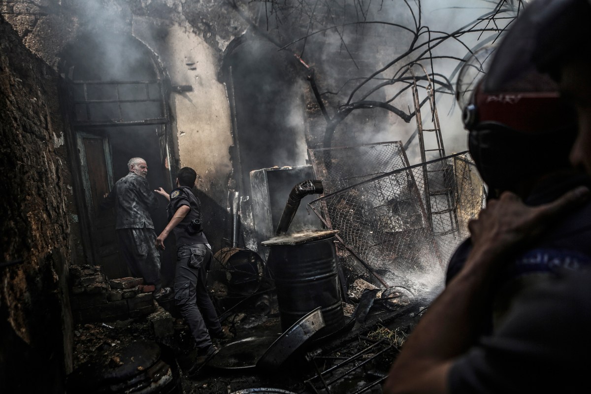 Firefighters at a man's home after an airstrike in Douma on Sept. 11. Mohammed BadraÃ¢Â€Â”EPA