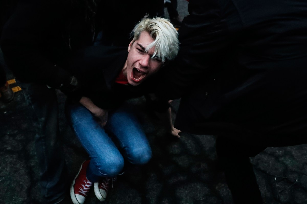 A protester cries out in pain after being hit by a bean bag round fired from police during a demonstration after the inauguration of President Trump in Washington, D.C., on Jan. 20, 2017.