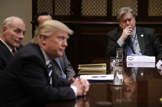 White House Chief Strategist Steve Bannon listens to President Donald Trump at the beginning of a meeting with government cyber security experts in the Roosevelt Room at the White House, on Jan. 31, 2017.
