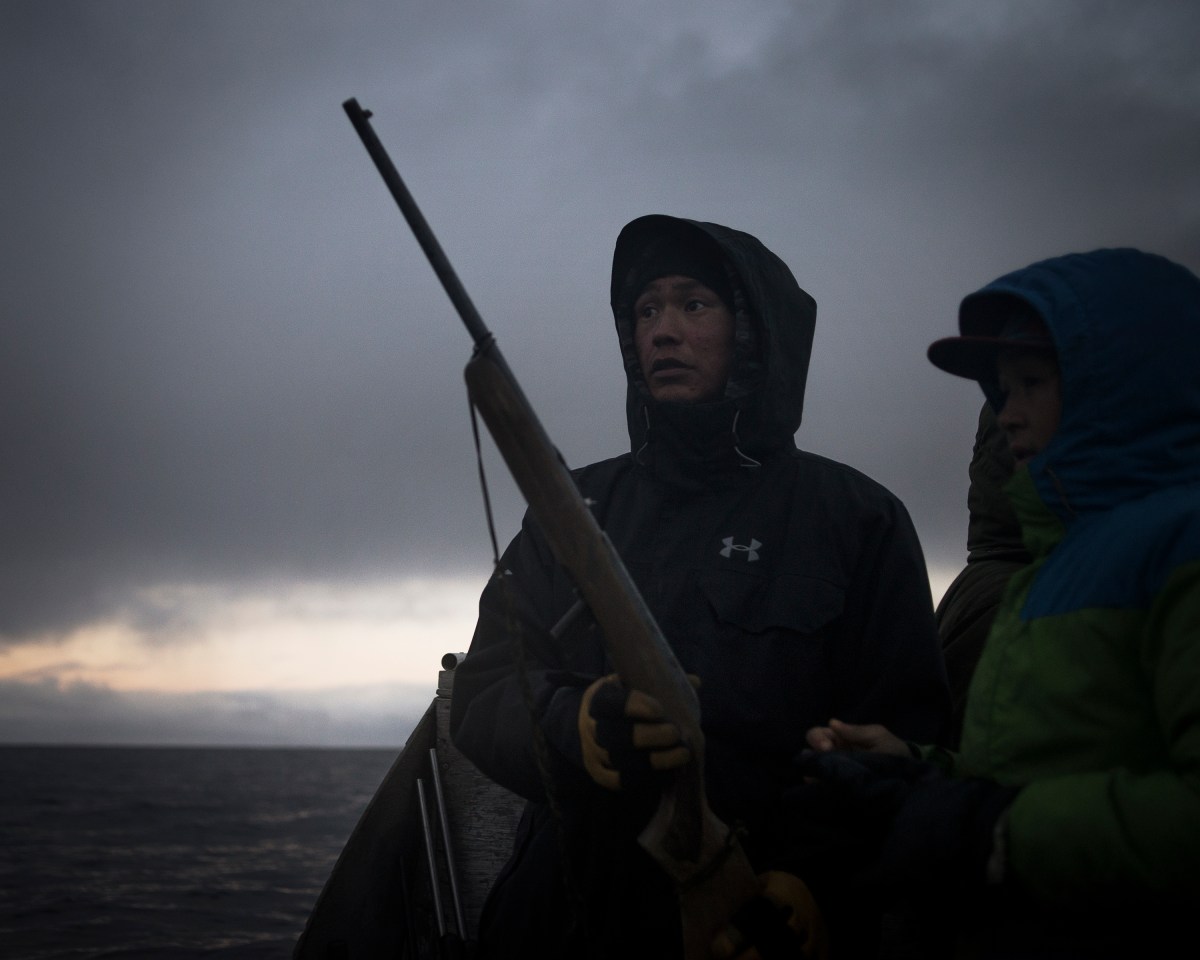 Nanasi Illauq, 26, and Markoosi Illauq, 15, scanning the water for seals. They grew up with hunting in the family.Nanasi has lost two of his older brothers to suicide, both at the age of 28. The family says there were no warning signs in either case. Traditionally people seek guidance and help from the well-respected elders when they feel lost or depressed. Today the community organization Ilisaqsivik also offers many forms of mental health services. But for Nanasi, hunting is one of the few things that makes him feel better. He caught his first seal when he was 12. “I was the proudest boy in the world,” he says, explaining that the hunting tradition gives him peace because it allows him “to be alone, where there’s nobody around to make me mad or make me depressed.”