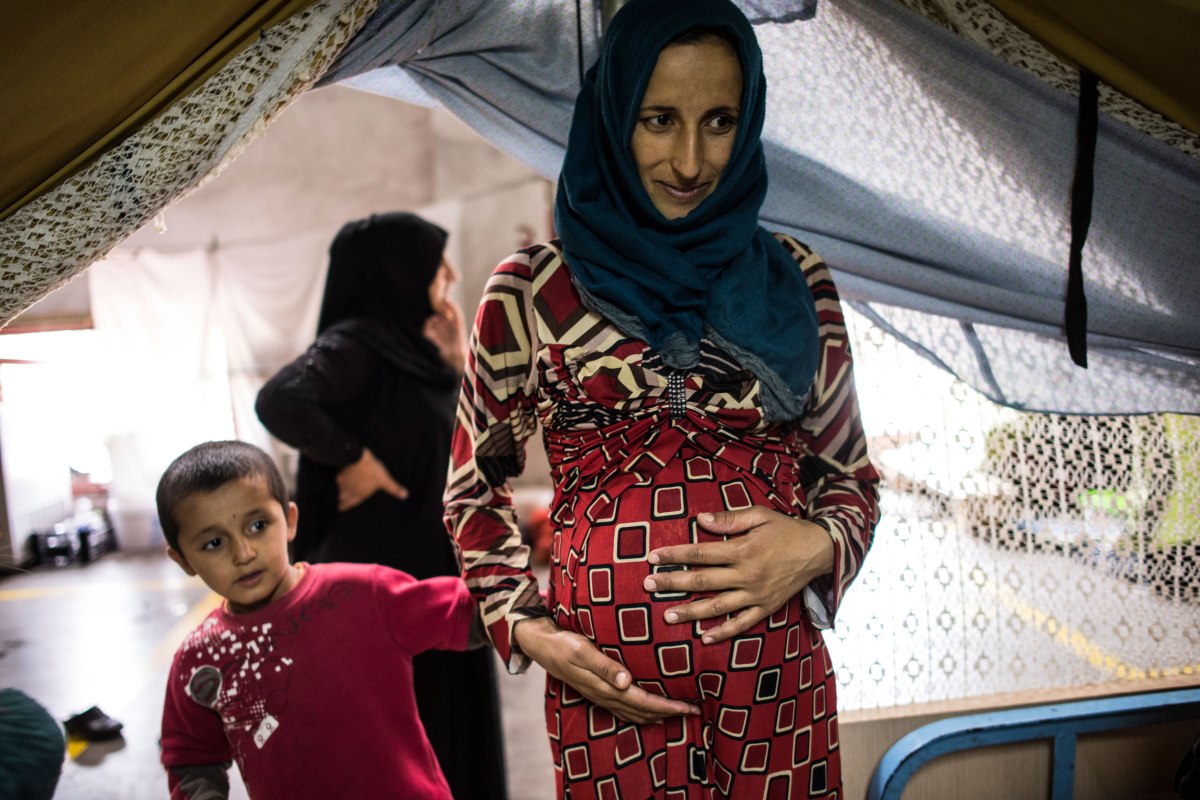 Pregnant with her fifth son, the 23-year-old mother from Deir ez-Zor, Syria, says “I don’t care where we go, as long as we go somewhere soon. Lynsey Addario—Verbatim for TIME