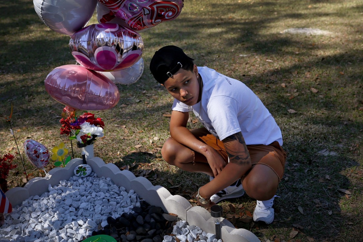 Kaliesha Andino, 19, visits the grave of her friend Omar eight months after the Pulse shooting in Orlando, Fla., on Sunday, February 12, 2017. Luis Omar Ocasio-Capo was 20 when he was killed during the shooting. They had been friends since middle school.(Photo by Preston Gannaway Â© 2017)