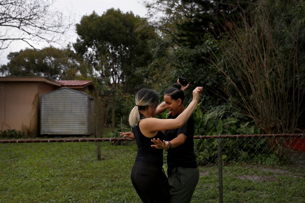 Kaliesha Andino and her girlfriend Adeline, who was visiting from Cleveland, dance while listening to music before heading out for a vacation eight months after Andino survived the Pulse shooting in Orlando. Kaliesha still finds it difficult to go out at night and has not been out to a club since the shooting.