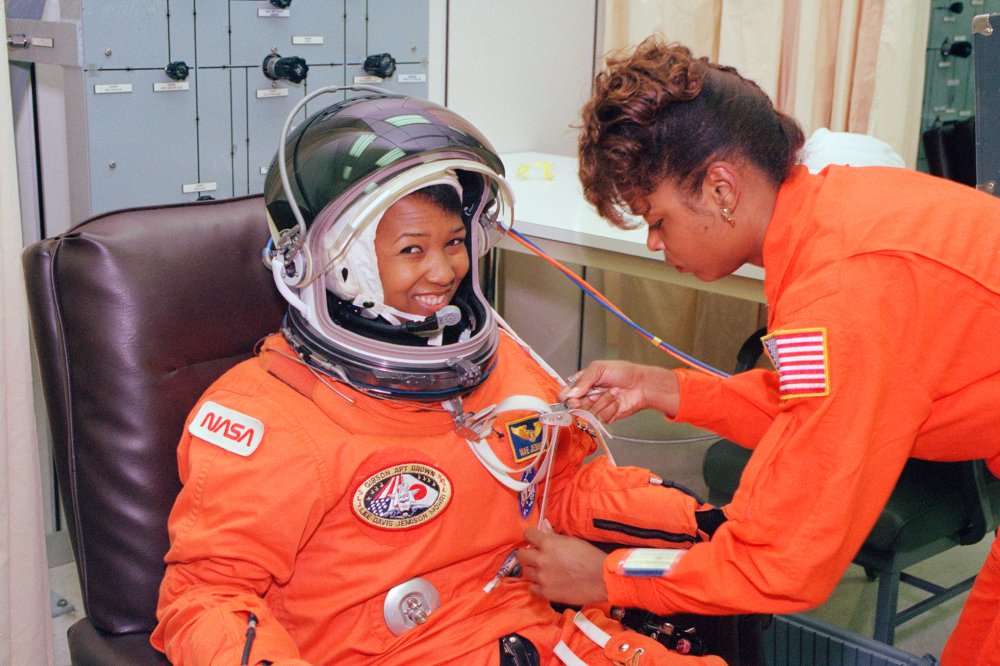 Mae Jemison waits as her suit technician performs a spacesuit check at the Operations and Checkout Building at Kennedy Space Center on launch day in September 1992. 