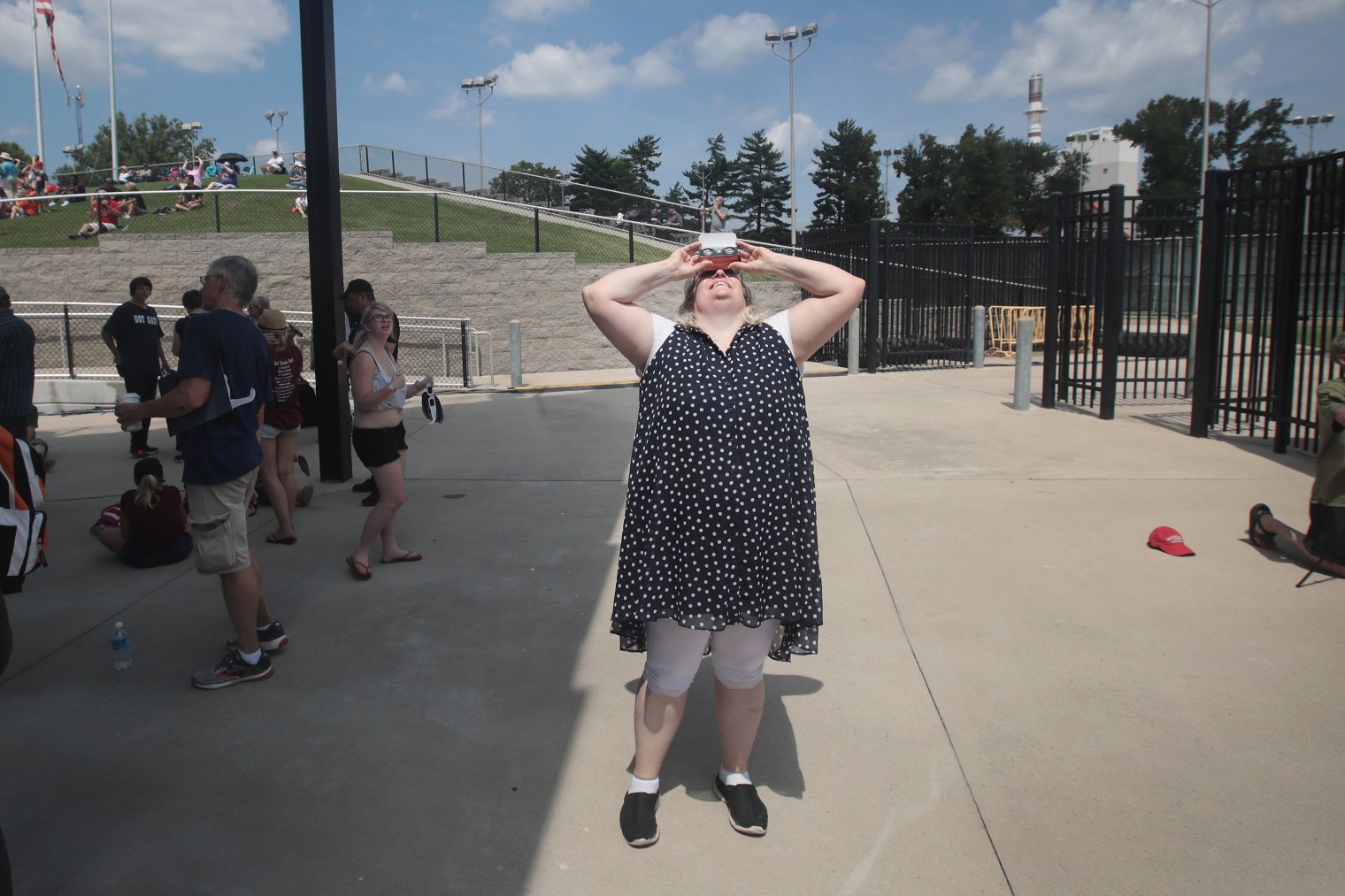 A woman watches the solar eclipse at Saluki Stadium on the campus of Southern Illinois University in Carbondale, Ill., on Aug. 21, 2017.