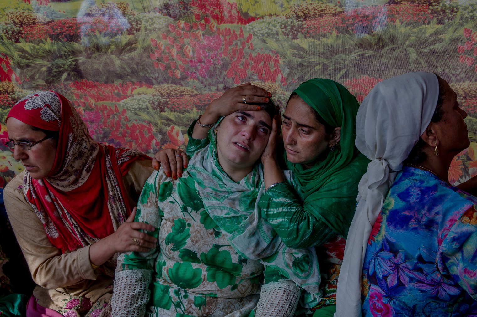 Relatives comfort the wailing sister of a Kashmiri civilian who was killed during a protest near the site of gun battle at her residence in Begumbagh, about 20miles (32 km.) south of Srinagar, on Aug. 1, 2017.