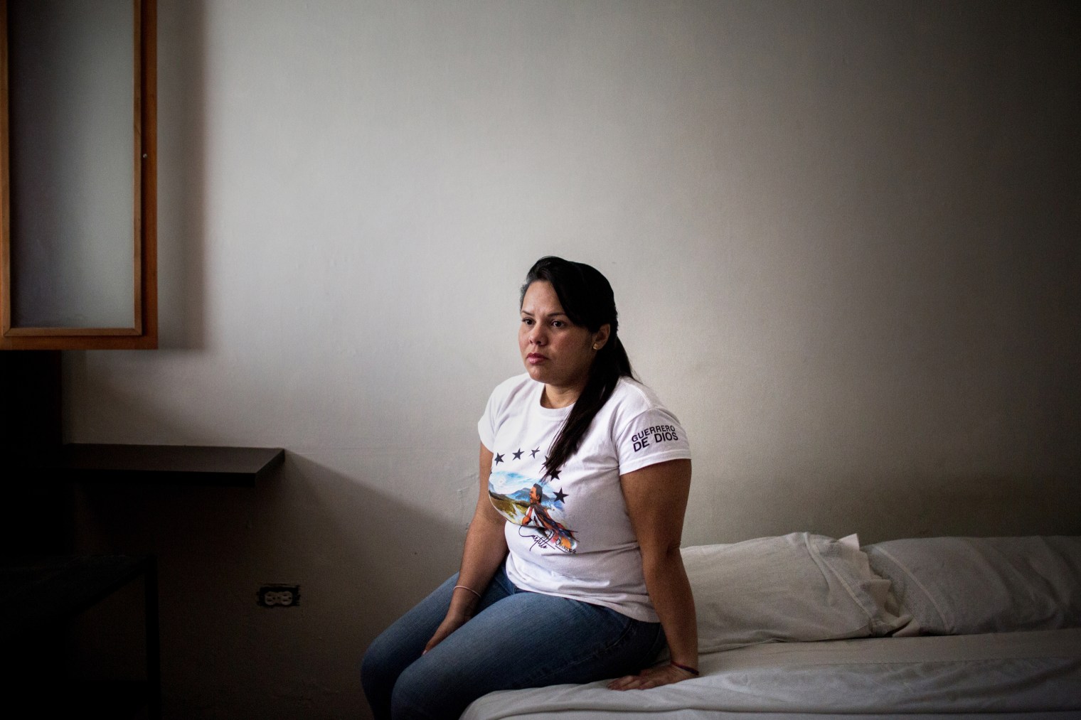 Luisa Castillo Bracho in the bedroom of her brother, Miguel Castillo, who was fatally shot at a May 10 protest, in Bello Monte on Aug. 1.