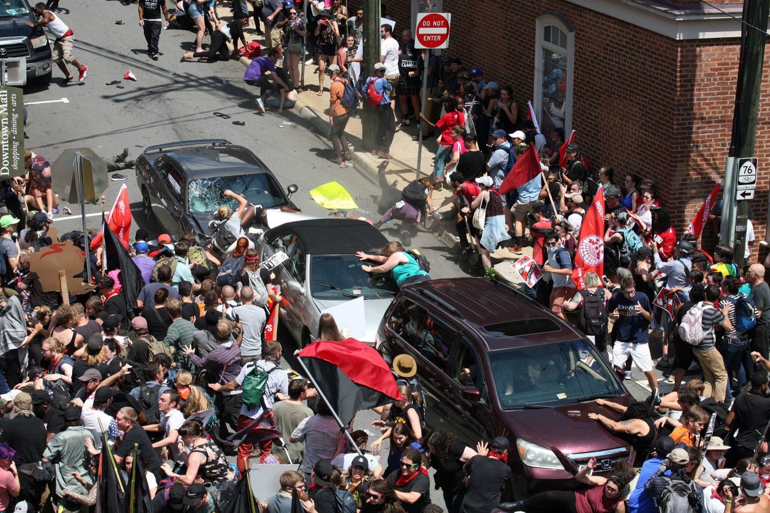 A gray car plows into pedestrians and vehicles as anti-white nationalism counter-protesters were marching through downtown Charlottesville, Va., on Aug. 12. The driver hit the knot of cars and people at high speed, then backed up and fled the scene.