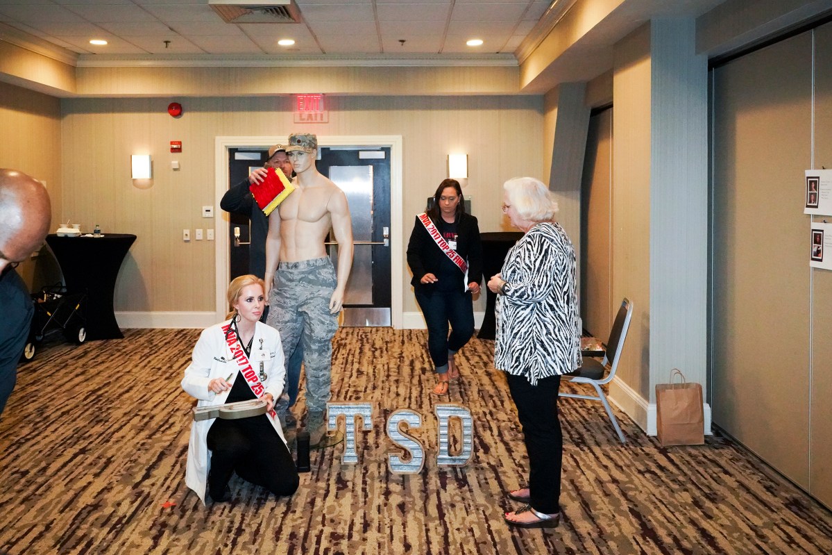 2017. Washington DC. USA. Kelli Wray sets up her presentation about her brothers death after a long struggle with PTSD during the preliminary judging. Ms. Veteran America is a pageant for active duty and retired female members of the armed forces. Part beauty pageant, part talent competition, part test of strength and commitment, the event raises funds for Final Salute, an organization providing housing and support for homeless women veterans and their children. Some of the participants danced and some sang, but many gave testimonials of sexual assault, PTSD and homelessness. Lindsay Gutierrez won the 2017 competition. The keynote speaker was the original "Daisy Duke", Catherine Bach.