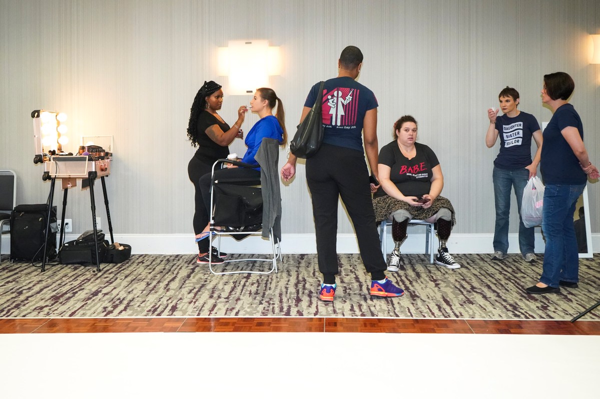 2017. Washington DC. USA. Makeup and official photo shoots before the 2017 Ms. Veteran America pageant in Washington DC. Founder Jaspen (Jas) Boothe in center and Marissa Strock (a double amputee who calls herself a "Glamputee") at center/right. She lost her legs in Iraq in 2005. She serves as the MC. Ms. Veteran America is a pageant for active duty and retired female members of the armed forces. Part beauty pageant, part talent competition, part test of strength and commitment, the event raises funds for Final Salute, an organization providing housing and support for homeless women veterans and their children. Some of the participants danced and some sang, but many gave testimonials of sexual assault, PTSD and homelessness. Lindsay Gutierrez won the 2017 competition. The keynote speaker was the original "Daisy Duke", Catherine Bach.