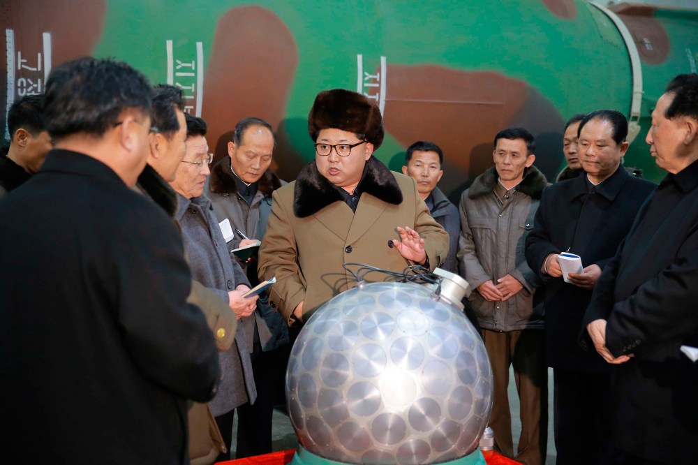 Kim stands before what state media described as a nuclear warhead for a ballistic missile in March 2016